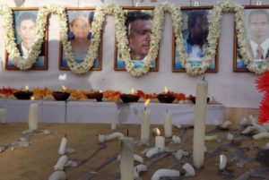 Candles are burnt in front of the photographs of 17 slain humanitarian workers from the French aid group Action Contre La Faim at their memorial in Batticaloa, Sri Lanka, August 11, 2006.  © 2006 Reuters